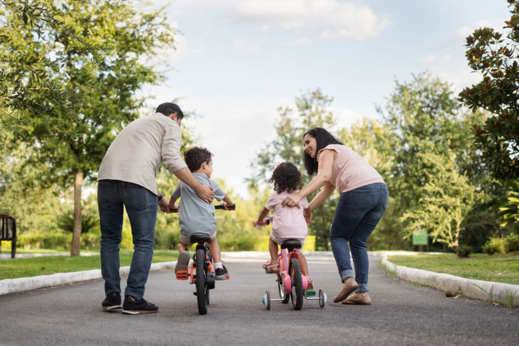family riding bikes in the park